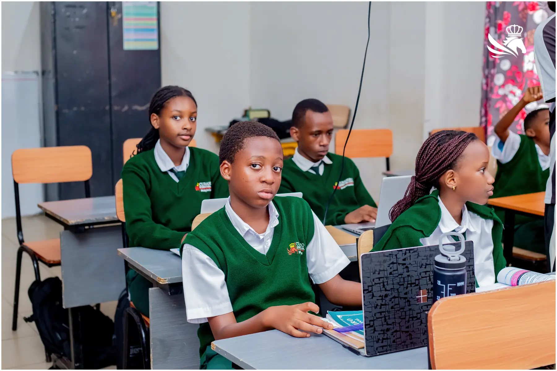 Students learning with laptops at Cubahiro International School